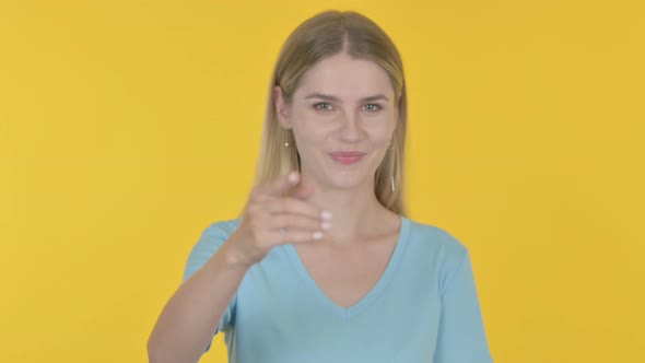 Young Woman Inviting on Yellow Background