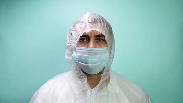 Man in Protective Suit Medical Mask and Gloves Looking in Camera