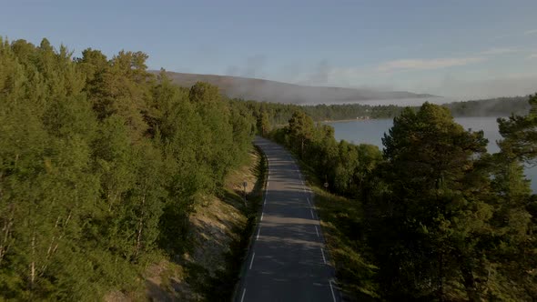 aerial shot of highway near Sjodals Lake, Jotunheimen, National Park, Norway. Shot Of Road At Nation