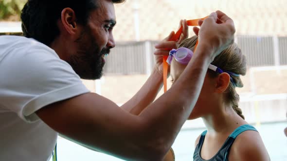 Male trainer giving gold medal to his student