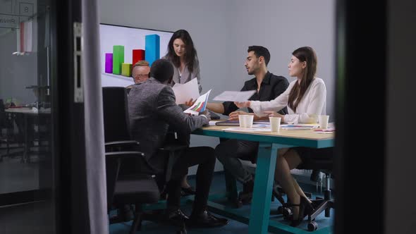 Wide Shot Group of Colleagues Brainstorming in Meeting Room in Office Indoors