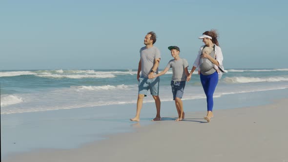 Happy Family Playing and Having Fun on the Beach Ocean