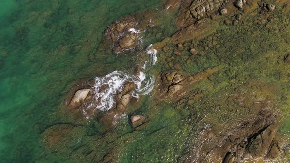 Clear waves - Rocky shoreline and turquoise clear Water - Natai, Thailand - Top view