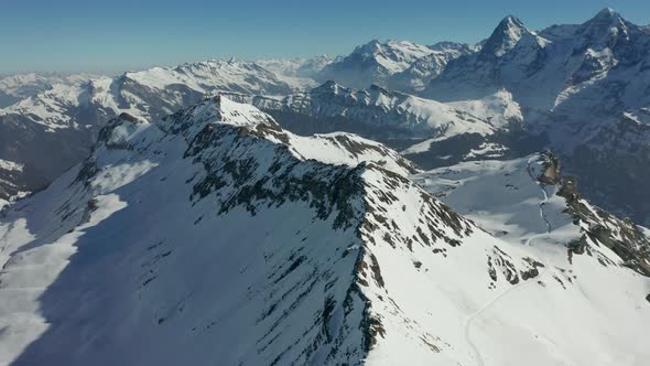 Stunning aerial of snow covered mountain top