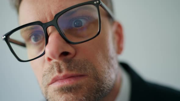 Portrait of a Formally Dressed Man in Glasses Looking Persistently Into the Camera