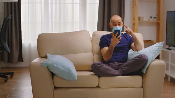 Man with Protection Mask Having a Video Call