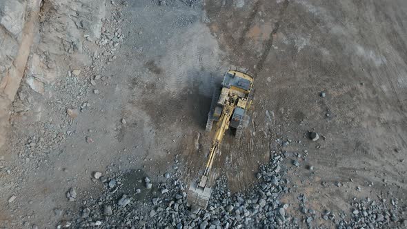 Rising Bird's Eye View of a Digger Working in a Quarry