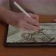 Talented Young Concept Artist Draws a Sketch of a Casual Game on a Digital Pen - VideoHive Item for Sale