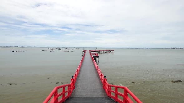 Long Red Japanese Styled Sea Bridge Lays into the Sea