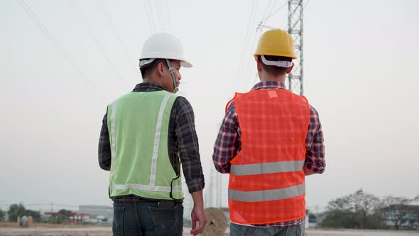 Two Electricity engineers working on the power plant. Teamwork industry a concept