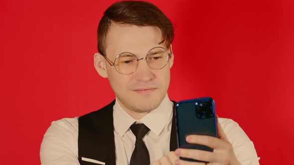 Smiling Man Using Cellphone in Studio