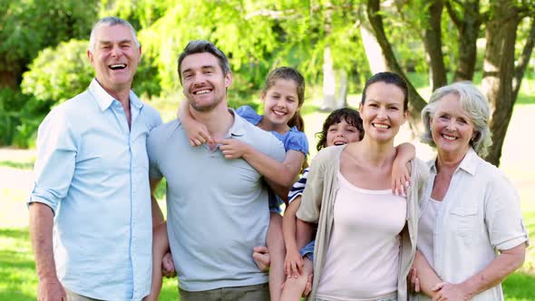 Extended family laughing at the camera in the garden