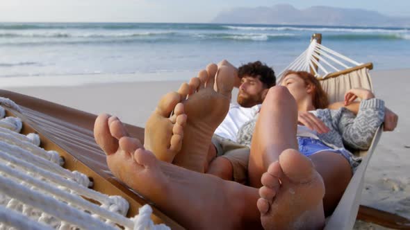 Couple sleeping on hammock at beach 4k