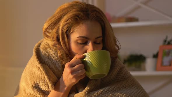 Sick Woman Covered in Blanket Drinking Hot Tea, Non-Traditional Treatment