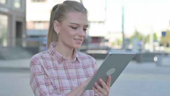 Young Woman Using Digital Tablet Outdoor