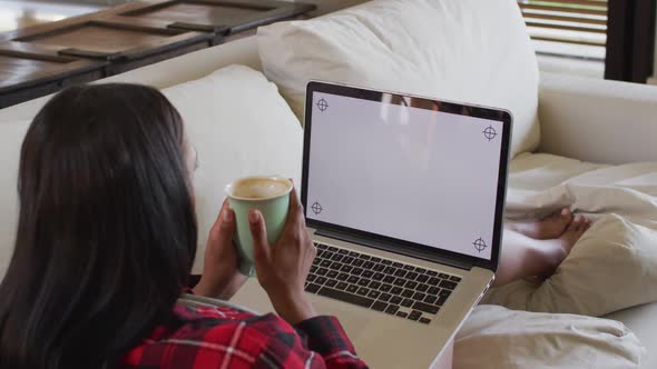 Mixed race woman on couch at home