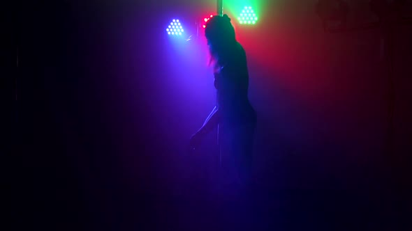 Silhouette of Girl Performing Erotic Dance in Dark