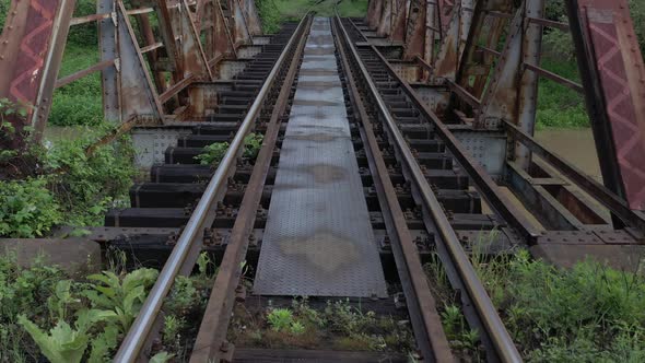 Single railway track over abandoned bridge 4K drone video