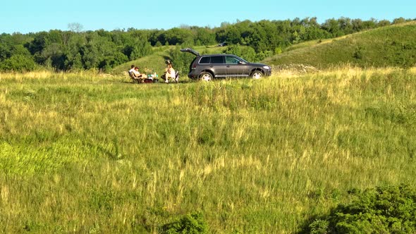 Picnic on the Background of Green Hills and Forest