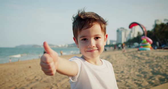 Cute Child Shows Thumbs Up Gesture Happy Facial Expression Emotion Glad Smiling Face
