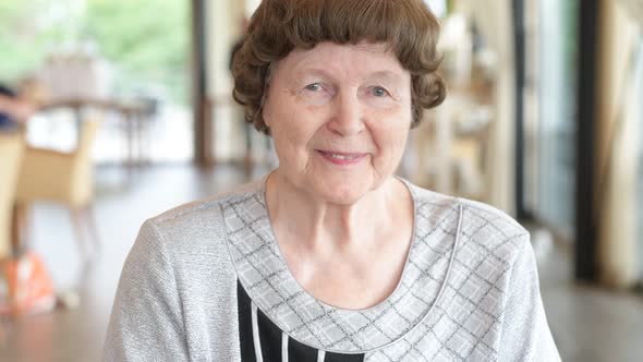 Beautiful Senior Woman Smiling At The Coffee Shop