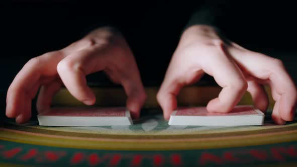 Close Up of Dealer Man Hands Mixing the Poker Cards