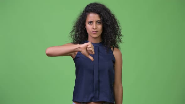 Young Beautiful Hispanic Businesswoman Giving Thumbs Down