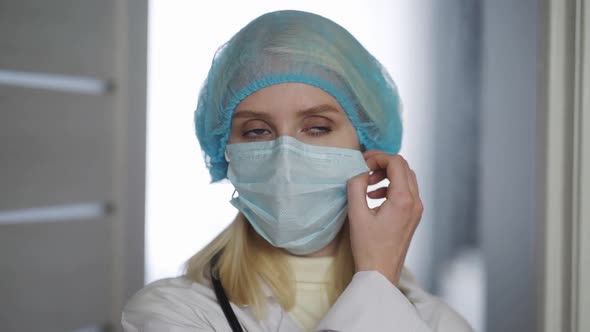 Female Doctor Remove Protective Surgical Mask After Complete Examination Job