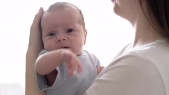 Mommy Tries to Calm the Crying Baby Shakes Him in Her Arms Dissatisfied Crying Upset Sad Newborn