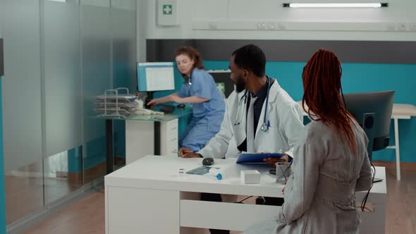 Male Obstetrician Giving Prescription Pills in Bottle to Future Mother