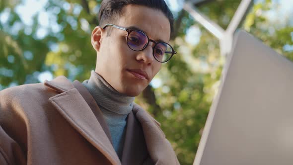 Handsome Arabian man working with laptop