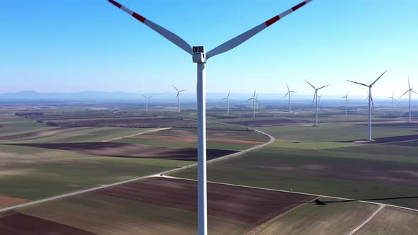 Wind Turbines And Agricultural Fields On A Summer Day - aerial drone shot