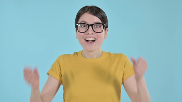 Happy Young Woman Celebrating with Her Hand Gesture on Purple Background