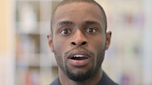 Close Up of Surprised Young African Man Looking at the Camera