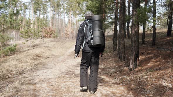 Tourist on a walk in the forest park. Orientation in the forest.