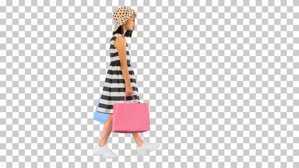 Cute little girl walking with shopping bags, Alpha Channel