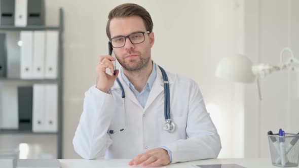 Male Doctor Talking on Smartphone