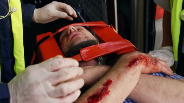 Emergency medical technicians examining the eyes of their wounded person