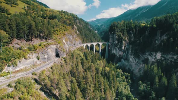 Landwasser Viaduct in Swiss Alps in Summer Aerial View on Green Mountain Valley