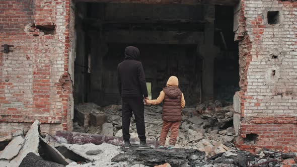 Father and Daughter Looking at Their Demolished House