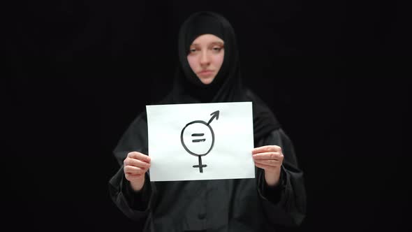 Closeup Sign of Gender Equality with Blurred Woman in Hijab at Background