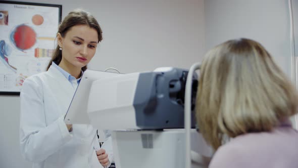 The Ophthalmologist Examines the Patient's Eye and Then Looks Into the Camera