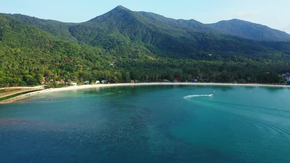 Aerial drone scenery of perfect coast beach holiday by blue green water with white sand background o