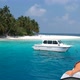 Boats near beautiful island beach in Maldives - Drone - VideoHive Item for Sale