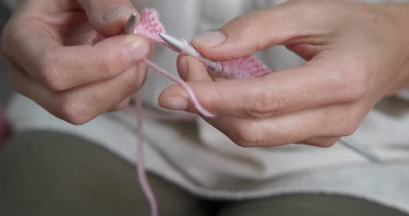 Knitting woolen sweater at home. 