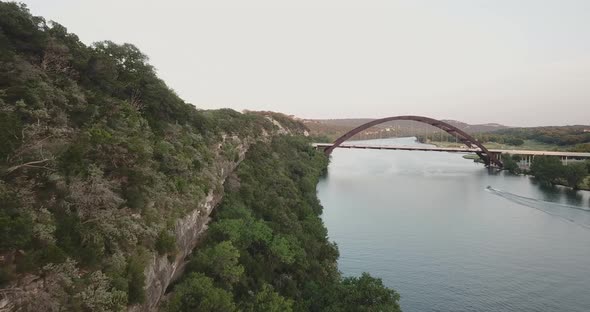 Aerial Drone Shot of the hills in Austin, TX, with the 360 bridge in the background.