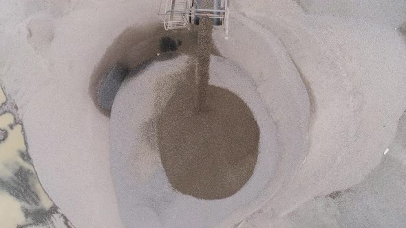 Aerial of a conveyor belt pouring sand