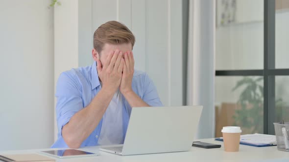 Young Creative Man with Laptop Having Loss Failure