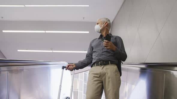 Caucasian man out and about in a metro station wearing on a face mask against coronavirus