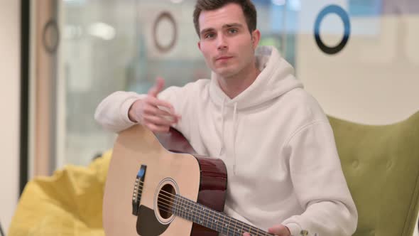 Man Playing Guitar During Video Chat Teaching Music